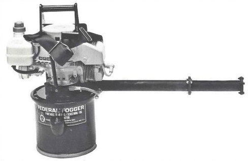 Black and white photo of a thermal fogger that is basically a 2-cycle weed-wacker engine on top of a chemical agent metal drum with a nozzle sticking out to the right that is about a yard long, it's dark and has some hardware on it. The drum says Federal Fogger and then other things that are illegible. The drum is a dark color and the main engine is light, with a dark handle and strap.